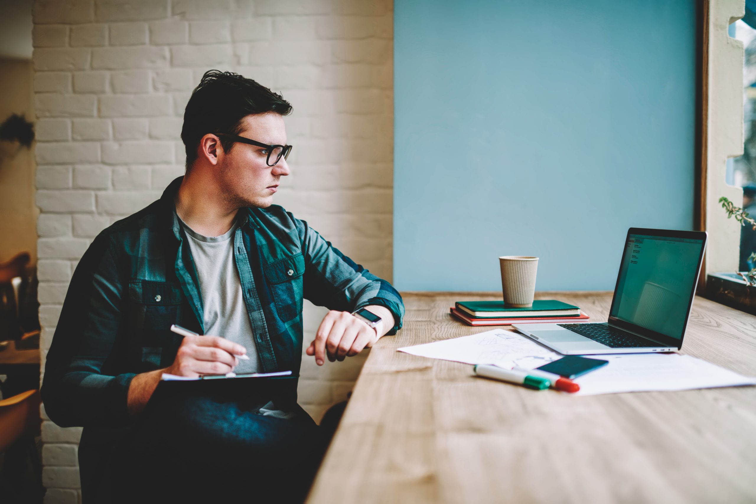 Man wearing glasses studying at a computer