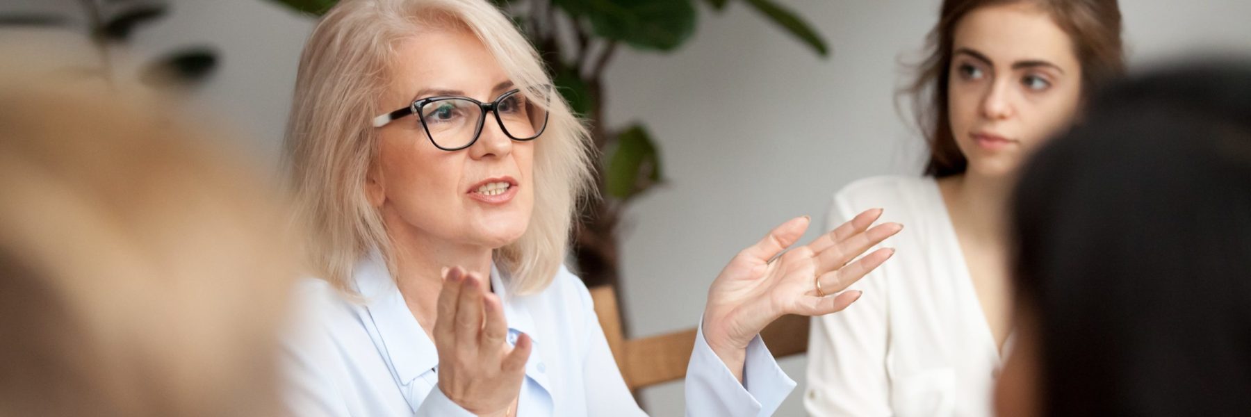 A woman explaining a workforce strategy gesturing with hands