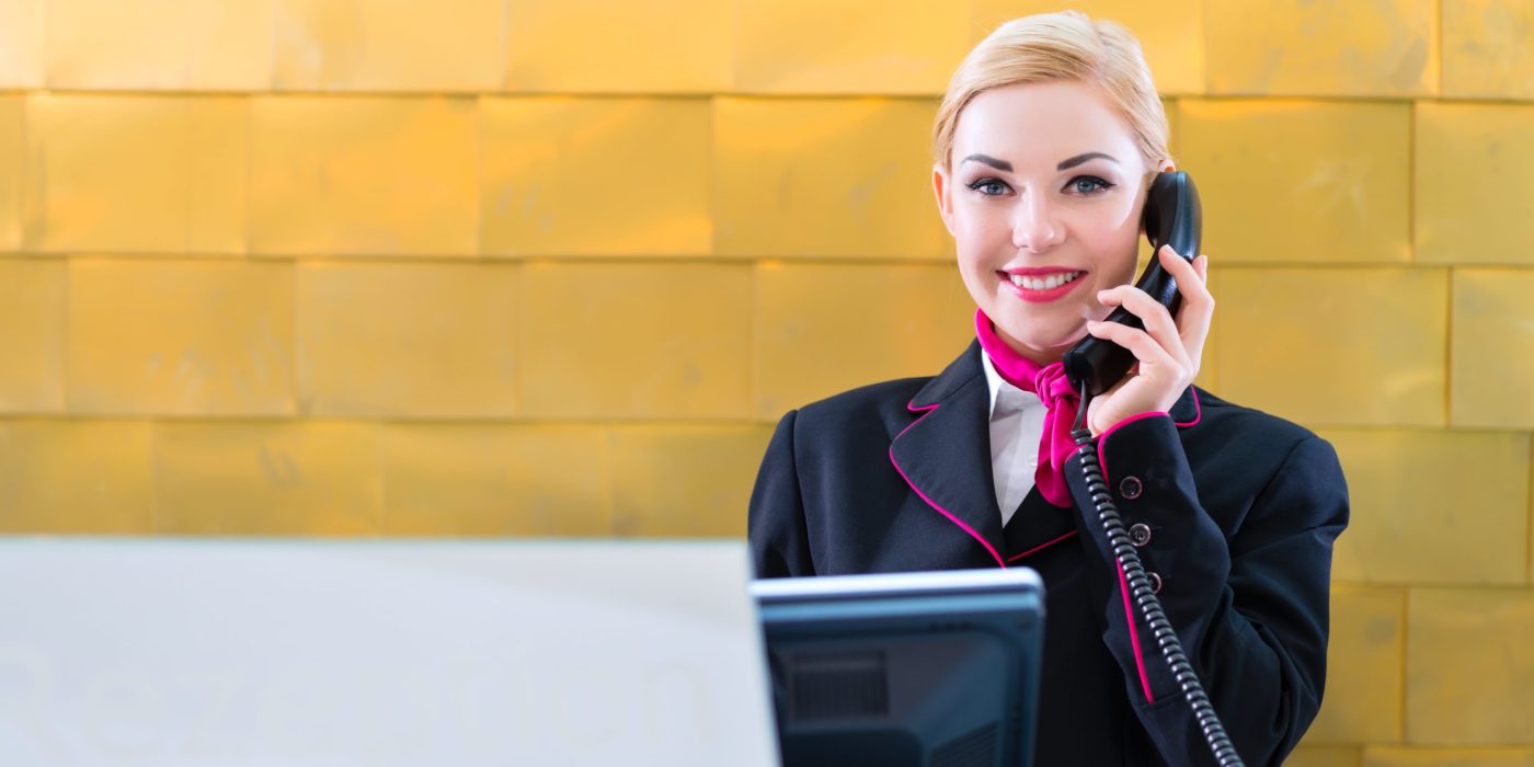 Woman airport assistant on the phone helping client to board plane